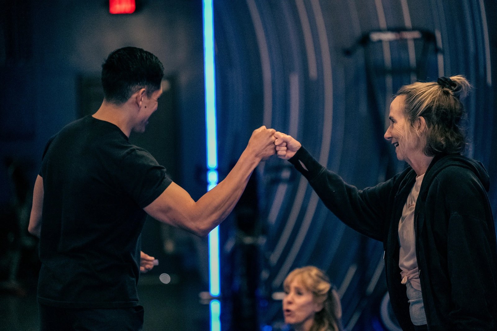 Coach high fiving a member after a session