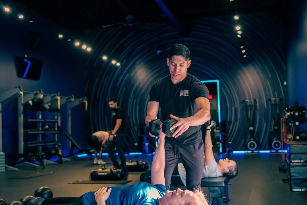 Two women training with a medicine ball and a kettlebell